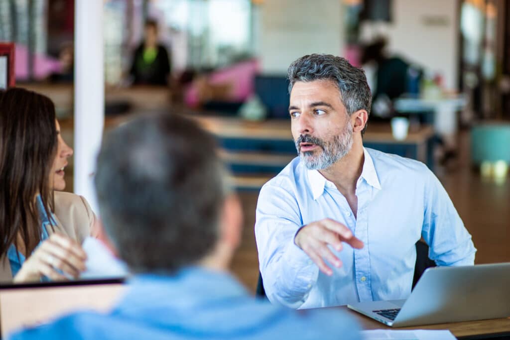 Close up of business colleagues working together in coworking office, 