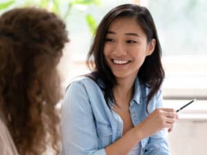 Two female colleagues have a conversation