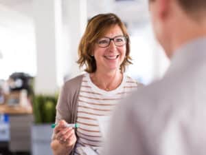 Woman boss speaking with her colleague