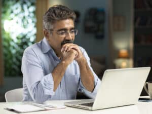 mature man working from home stock photo