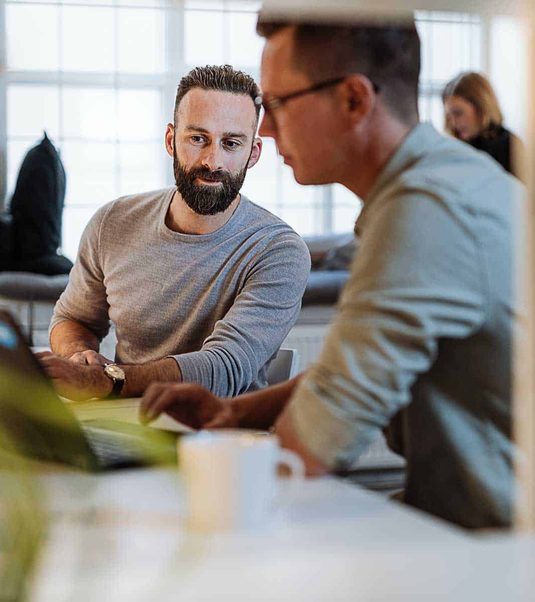 two male colleagues discuss legal jobs