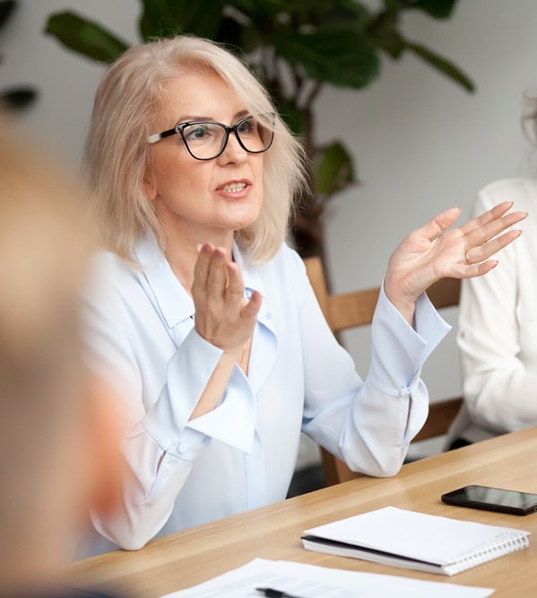 Female professional explains concept at business meeting