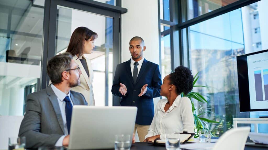 Leader leading group discussion around table