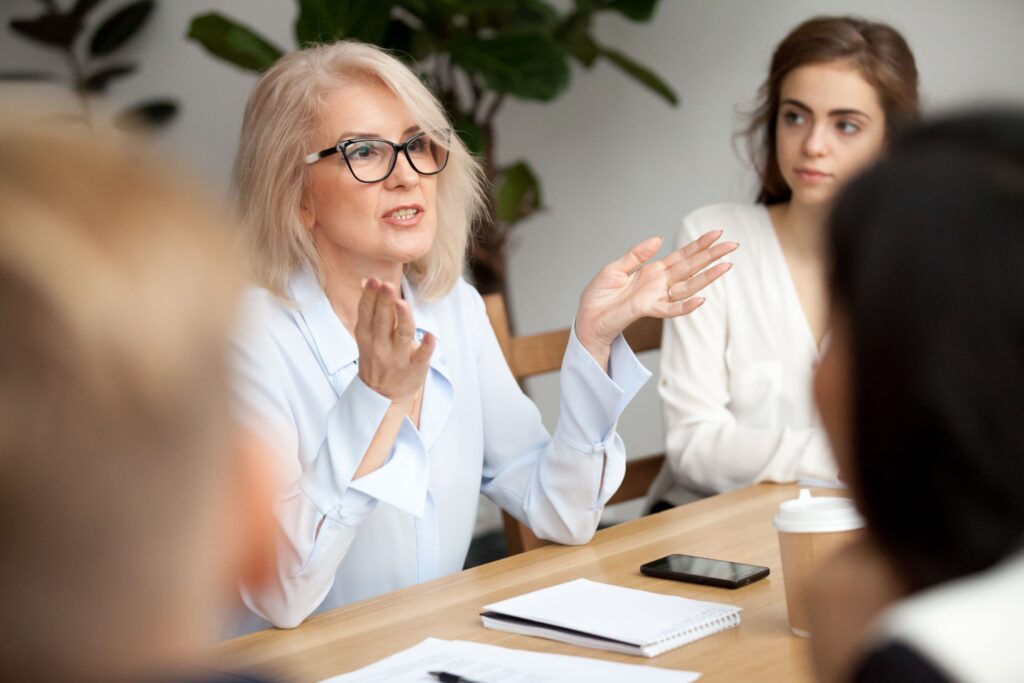 Professionals meet in person in an office