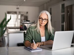 Professional woman working at desk and laptop