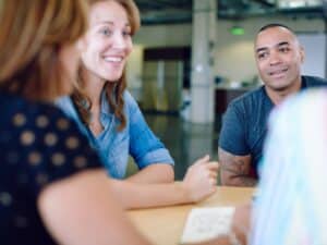Candid picture of a business team collaborating. Filtered serie with light flares and cool tones.