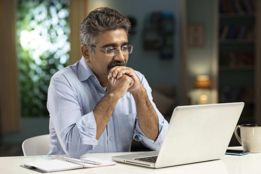 mature man working from home stock photo